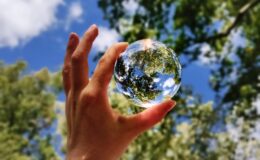 unknown person holding clear glass ball