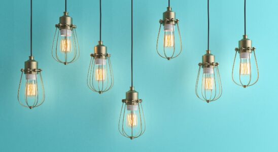 Seven vintage lamps hanging from the ceiling with blue wall 3D renderind