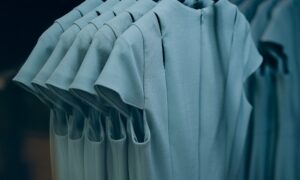 Closeup shot of hanging gray dresses on a textile industry