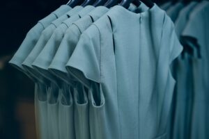 Closeup shot of hanging gray dresses on a textile industry