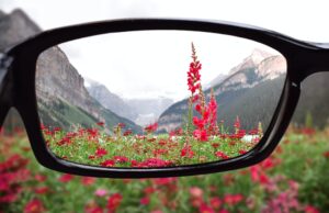 Looking through corrective eyeglasses lenses at nature