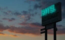 turned-on green hotel LED light signage ahead