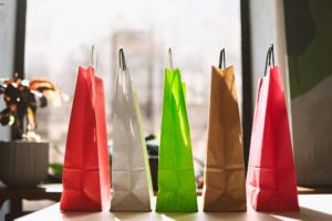 Close up colorful shopping bags on table with big window on back