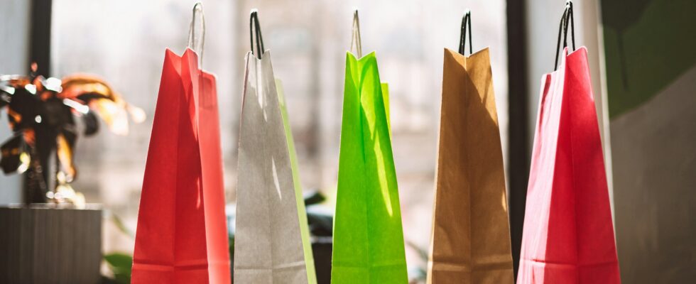 Close up colorful shopping bags on table with big window on back