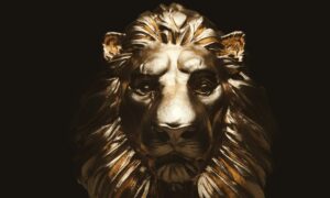 Lion statue, a gold sculpture. Concept of a guard, power and proud animal.