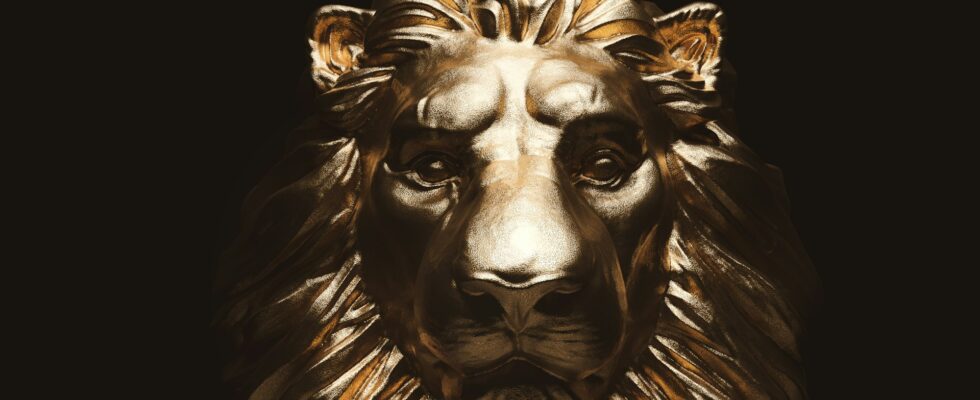 Lion statue, a gold sculpture. Concept of a guard, power and proud animal.