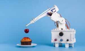 Robot cooking dessert, decorating sweet cupcake with fresh cherry