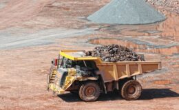 dumper truck driving in an active quarry mine of porphyry rocks. digging
