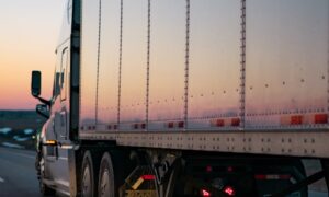 white freight truck on road during daytime