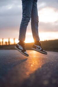 a person standing on a skateboard on a road