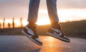 a person standing on a skateboard on a road