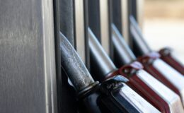 a row of knives hanging on the side of a building