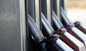 a row of knives hanging on the side of a building