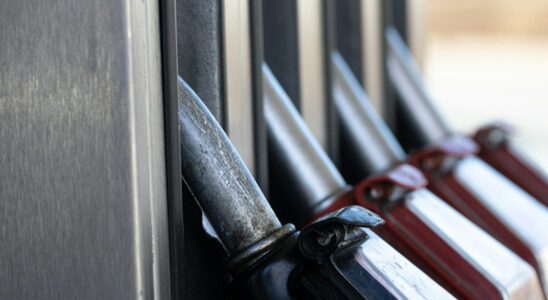 a row of knives hanging on the side of a building